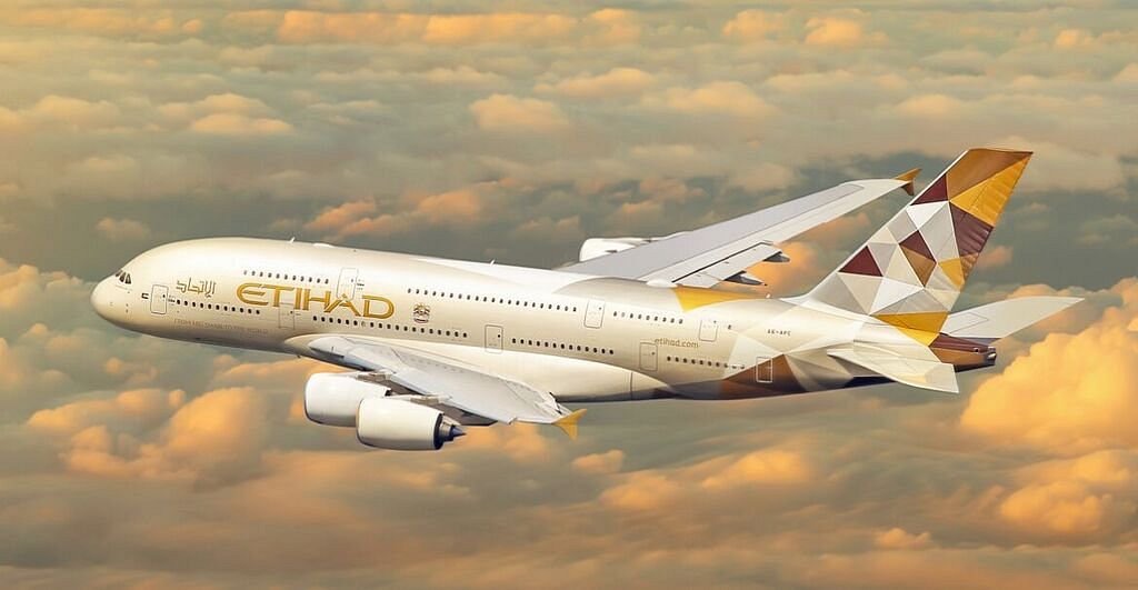etihad A380 flying over clouds