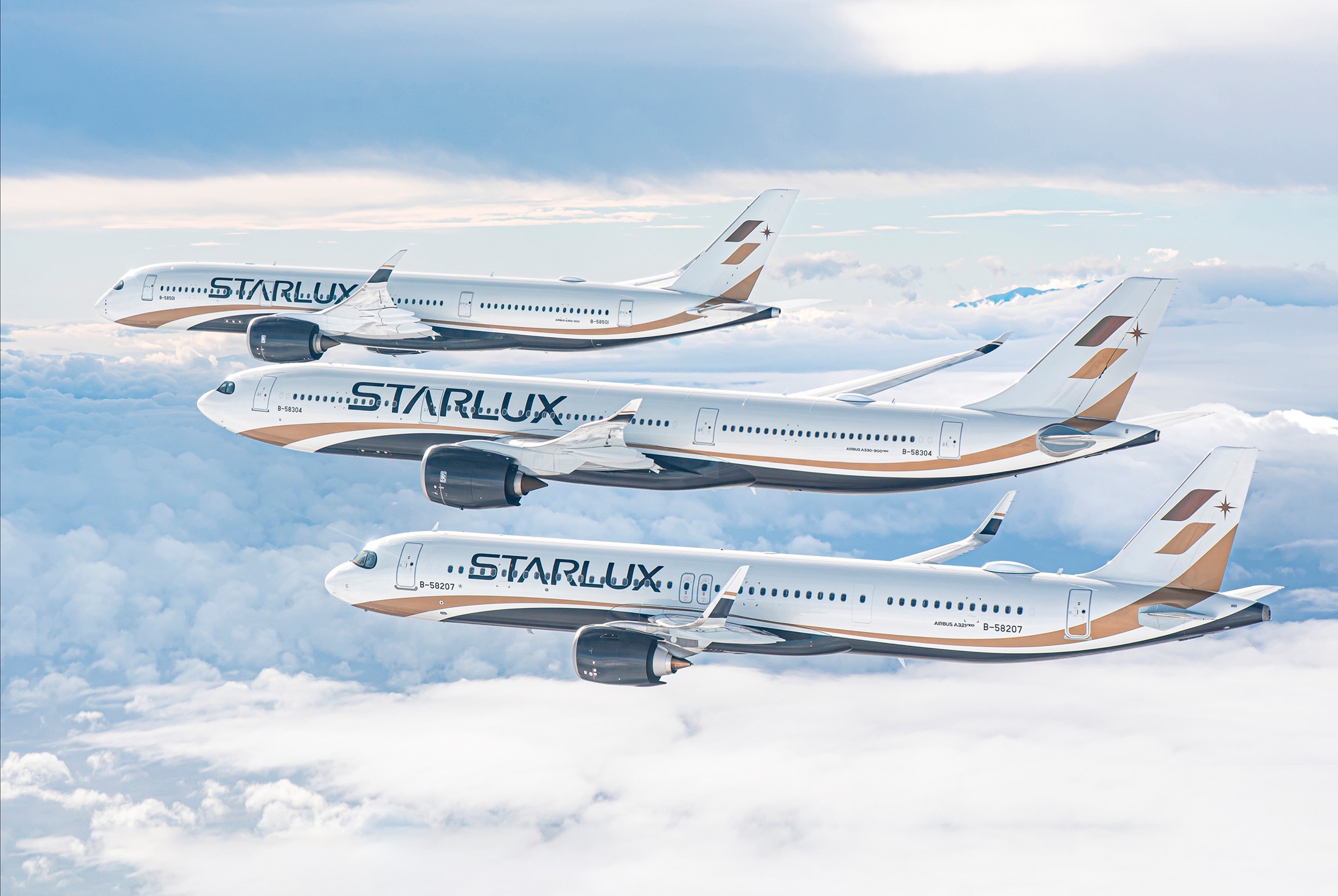 three Starlux airlines flying in the sky